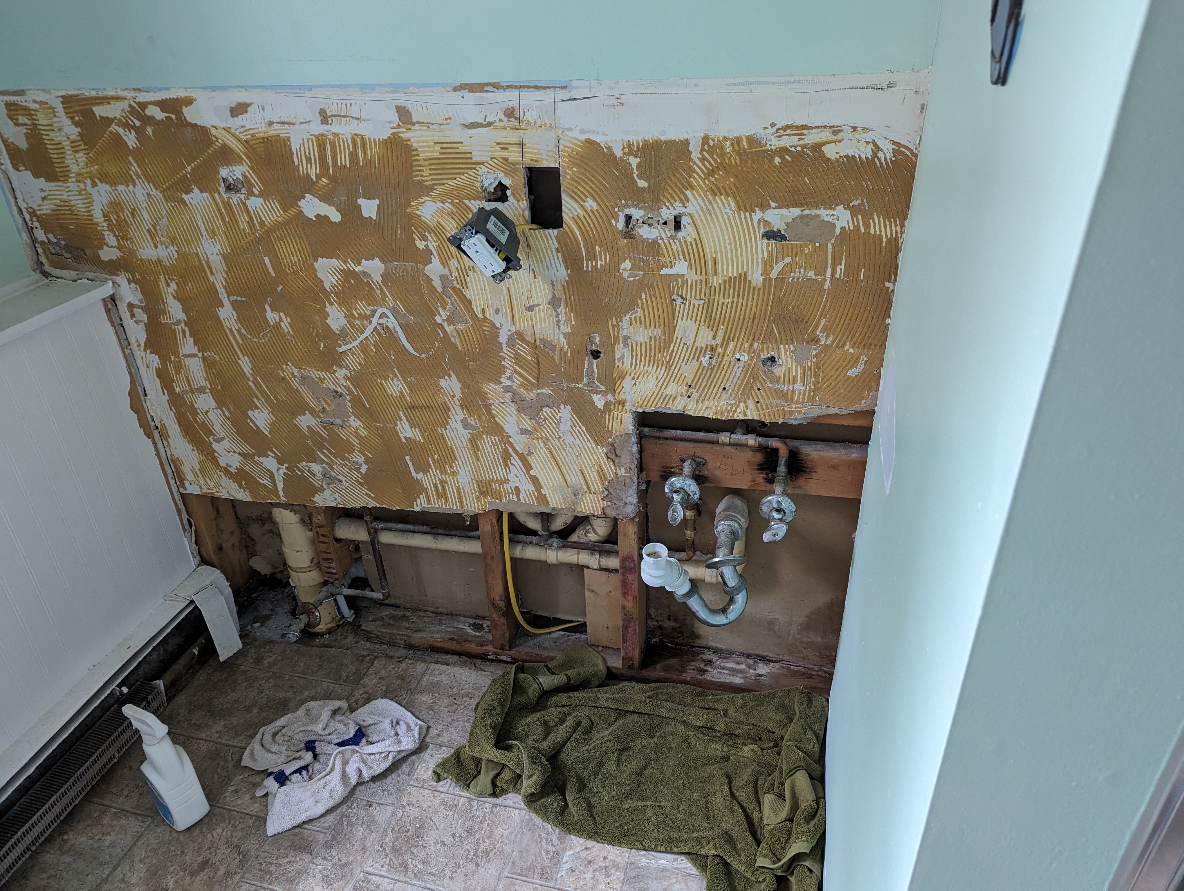 The bathroom wall after the paneling was removed